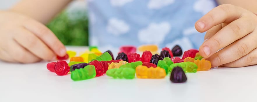 Child with jelly candies. Selective focus. kid.