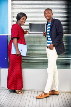 businessman and businesswoman standing confident smiling in the street holding in hand folder and computer
