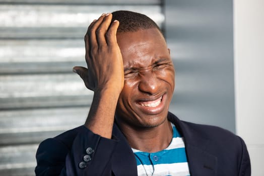 young businessman standing in suit outdoors suffering from headache.
