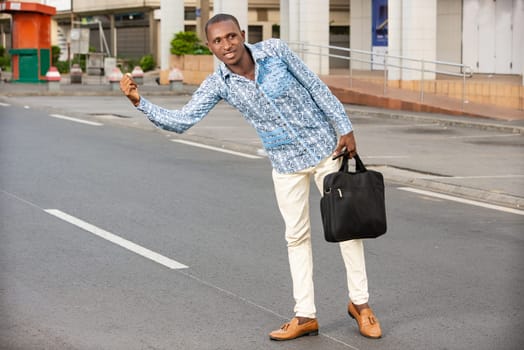 young smiling businessman with bag in hand.