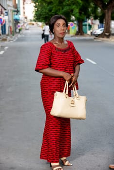 beautiful businesswoman standing in traditional outdoor outfit looking at the camera while talking.