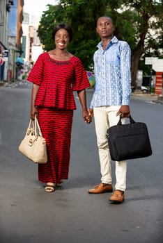 happy couple walking together outdoors on the street being happy