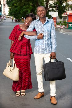 Businessman and businesswoman walking together on the street being all happy