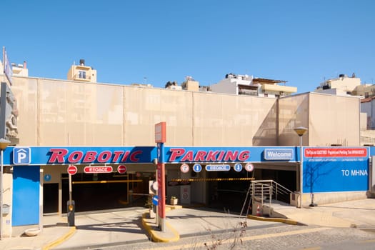 Crete.Greece - april 13, 2025: A state-of-the-art robotic parking facility featuring advanced automation, efficient design, and signage under sunny skies, representing modern technology.