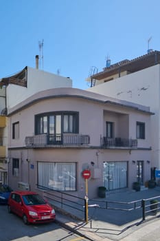 Crete.Greece - april 13, 2025: An aged residential house in Heraklion with peeling paint, metal balcony railings, and rustic details, capturing the essence of urban decay and charm.