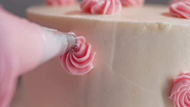Unrecognizable Woman Chef Decorating Bento Biscuit White Cake with Cream Rose Flowers And Leaves. Pastry Art, Floral Details. High quality
