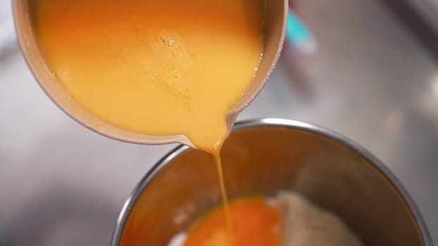 Yellow yolks are added in metal stand mixer bowl. Whipping eggs for baking. Baking, recipes, sponge cake, cookies, desserts. Omelette, breakfast concept. Quality