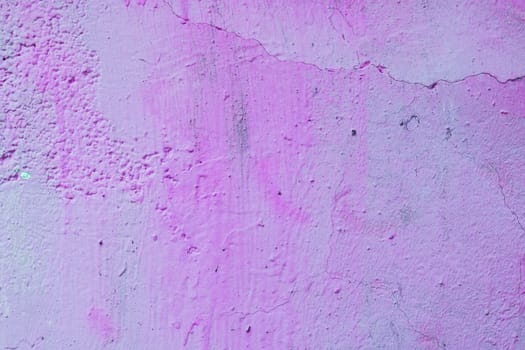 Old, worn wall with stains. Abandoned purple wall.