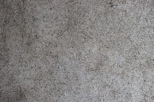 Close-up of a grey, rough concrete wall.
