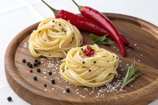 Twirls of fresh pasta are artfully arranged on a rustic wooden plate, accompanied by vibrant chili peppers and a sprinkle of peppercorns, creating an inviting culinary display.
