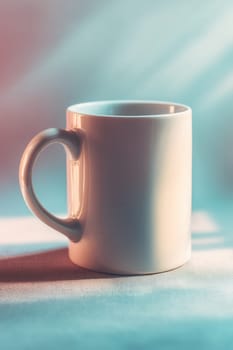 White ceramic mug on fabric with soft pastel pink and blue lighting. Ideal for product mockups, lifestyle branding, morning coffee visuals, and clean minimalistic designs