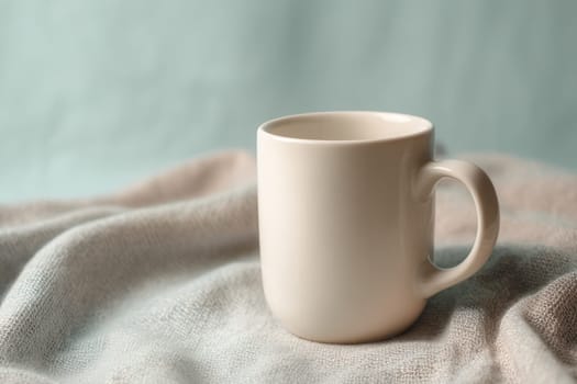 Minimal ceramic mug placed on gentle fabric with a soft pastel blue background. Great for cozy lifestyle visuals, product branding mockups, or hot drink-related content