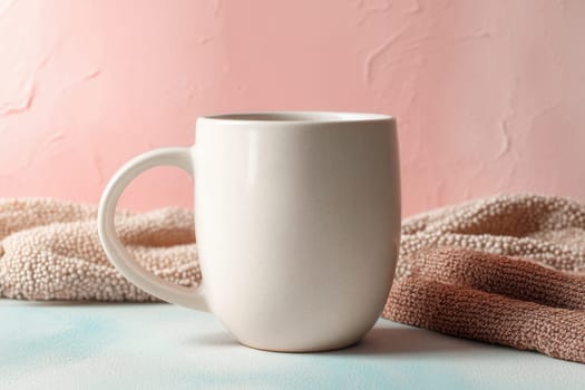 Ceramic mug on cozy textured fabric with soft pink wall and pastel backdrop. Ideal for lifestyle branding, product mockups, and hot beverage themed visuals
