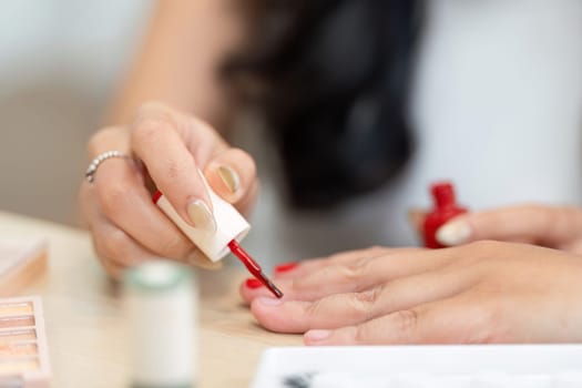 A shared nail art moment as friends take time to enhance personal style with creative nail color, celebrating beauty and creativity together.