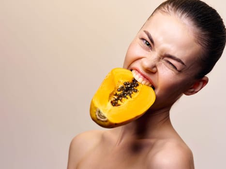 Woman enjoying the taste of fresh papaya with eyes closed in a serene moment
