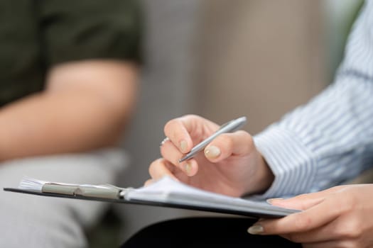 A psychiatrist carefully documents vital information during a session, enhancing the therapeutic process and client understanding.