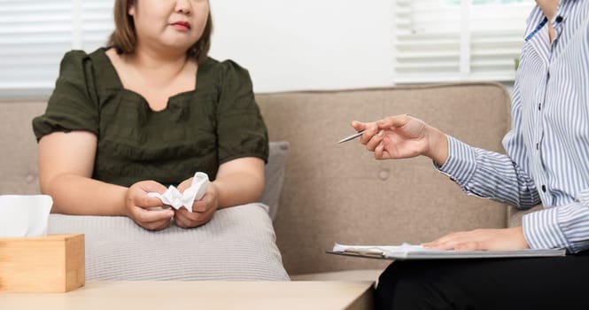 A therapist creates a safe space for her client to express emotions while providing guidance and support through a challenging moment during their session.