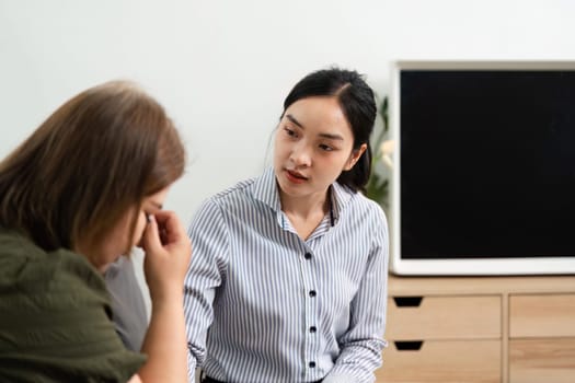 A dedicated psychiatrist comforts a client experiencing emotional distress, creating an environment conducive to healing and support.