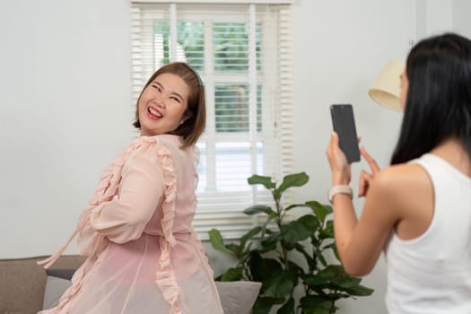 A cheerful woman poses for a photo during a beauty session, exemplifying fun and friendship in a light-hearted environment filled with beauty products.
