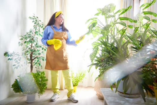 The gardener cares for flourishing plants while enjoying the warm sunlight.
