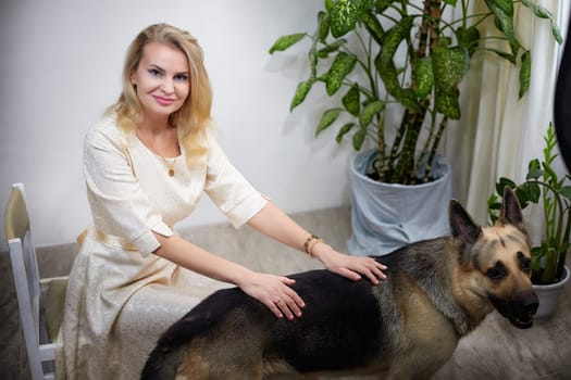 Blogger poses with her German shepherd in a cozy indoor setting, highlighting their bond during the photo session.