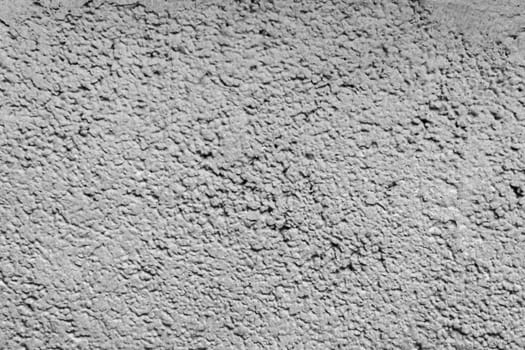 Close-up of a grey, rough concrete wall. Old, rough gray plaster. Texture for design.
