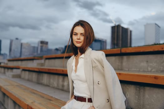 This portrait captures a confident woman in a stylish business outfit, exuding professionalism and elegance in an urban setting, ideal for corporate themes.