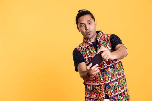 Man having surprised look on face after being defeated while playing videogames on smartphone. Person having shocked facial expression after being beaten by other players, studio background