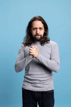 Confident serious person feeling enthusiastic about something on camera, being ecstatic with a vibrant ambitious attitude. Middle eastern guy being self assured and satisfied or pleased.