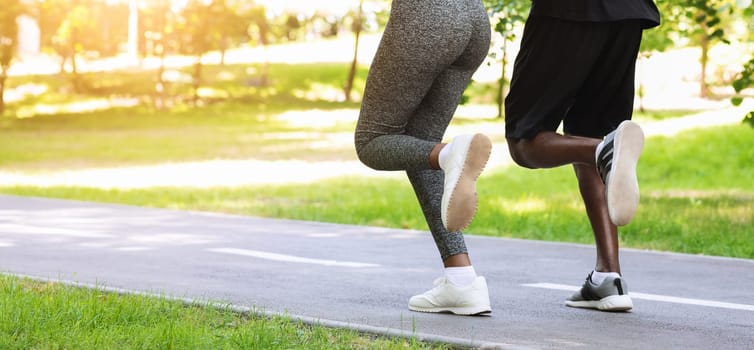Active Lifestyle. Unrecognizable Black Couple Running Together In Morning Park, Rear View, Cropped Image With Free Space