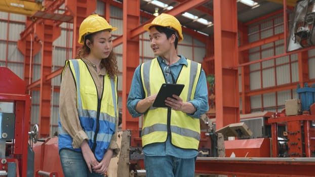 Factory manager and worker discuss something together with tablet computer, Two multiethnic metal sheet industrial workers meeting and discussing to new project plan, Quality control management