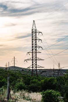 Electricity pylons distributing energy in the Crimean peninsula at sunset