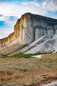Scenic view of White Rock, a prominent natural landmark in Crimea, showcasing its majestic limestone formations against a backdrop of a beautiful sunset sky