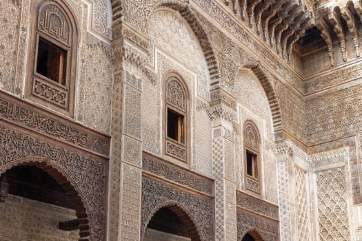 Closeup view of rich decorated facade in the courtyard of the Al-Attarine Madrasa in Fes. Morocco. Horizontally. 