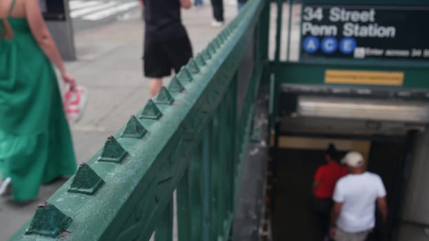 New York City, United States - 29 Aug 2023: Subway sign, underground metro station. Metropolitan entrance, Manhattan public transport. Pedestrians people. 34 street, Penn Station, passenger railroad.