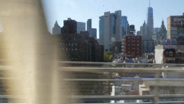 New York City, United States - 14 Sept 2023: Subway train, Manhattan bridge. Shaking camera, dirty window. Metro transport metropolitan traffic. Passenger railway. Downtown skyline. World Trade Center