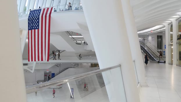 New York City, United States - 10 Sept 2023: World Trade Center Oculus transport hub architecture. Manhattan Downtown Financial District, USA urban life. People. September 11 remembrance american flag