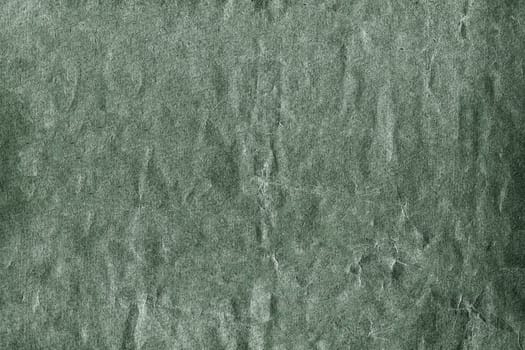 Green textured background ideal for grunge designs, showcasing a rough surface with cracks and scratches, adding a vintage or distressed effect