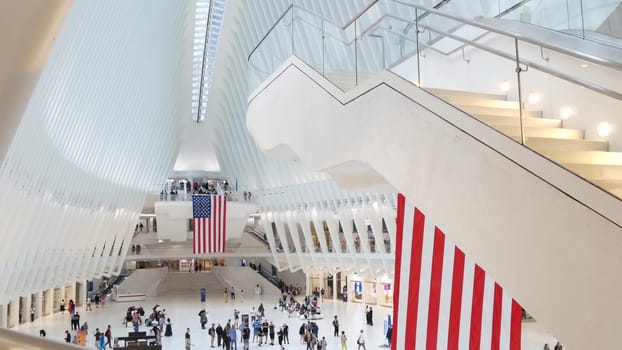 New York City, United States - 10 Sept 2023: World Trade Center Oculus transport hub architecture. Manhattan Downtown Financial District, USA urban life. People. September 11 remembrance american flag