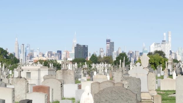 New York City, United States - 14 Sept 2023: Calvary cemetery in Queens, USA. Manhattan Midtown urban skyline cityscape architecture. Tombstones on graves, huge graveyard. Large cemetry grass lawn.