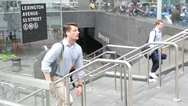 New York City, United States - 11 Sept 2023: Manhattan Midtown Lexington avenue, United States. People pedestrian exit underground subway station, stairs on 53 street, urban USA. Metro entrance sign.