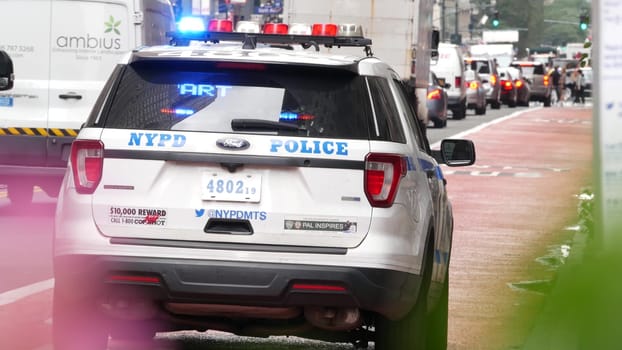 New York City, United States - 29 Aug 2023: Police patrol car, USA NYPD, 911 vehicle on Manhattan Midtown 34th street. American cop auto siren on avenue, urban traffic scene, Herald square in NYC.