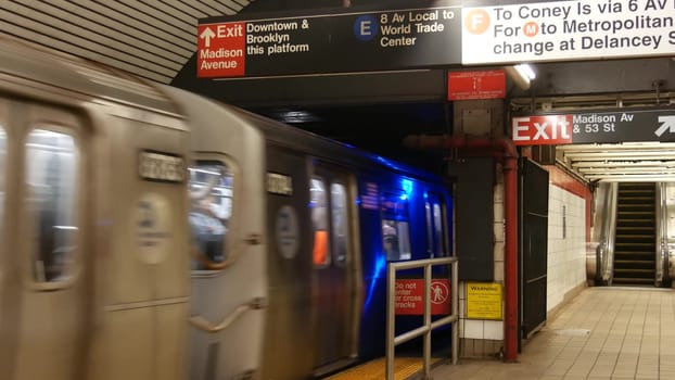 New York City, United States, 31 Aug 2023: Subway station interior, underground metropolitan platform sign. Metro train railway transport. Text signboard: Downtown, Brooklyn, Madison Avenue. Manhattan