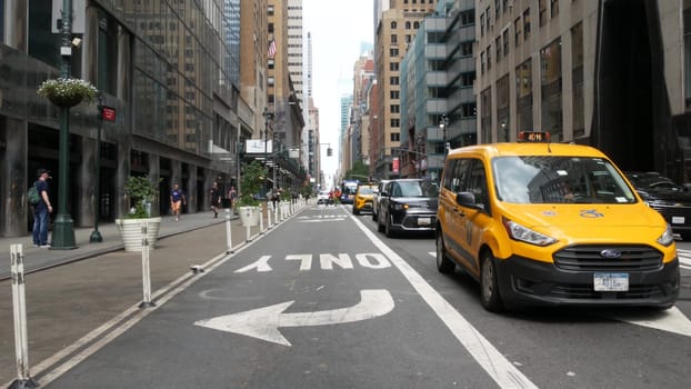 New York City, United States - 4 Sept 2023: Manhattan Midtown East 42 street, Lexington Lex avenue crossroad intersection. Urban road car traffic in USA. People, yellow taxi cab near Chrysler building