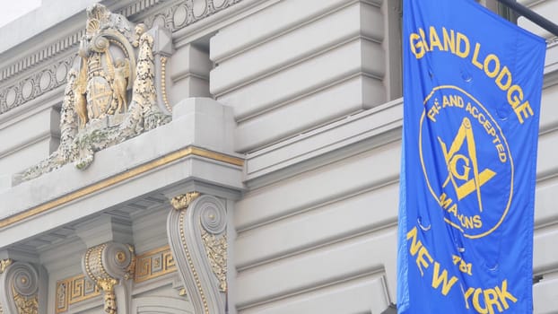 New York City, United States - 6 Sept 2023: Grand Lodge of Masons building facade, Manhattan street. Freemasons headquarters architecture. Masonry organization in NYC, USA. Masonic Hall exterior. Flag