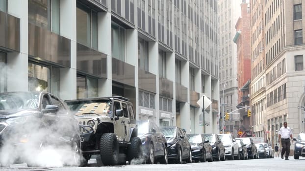 New York City, United States - 9 Sept 2023: Hot smoke from manhole, Con Edison's Steam system. Vapor from road, car on Beaver Street, NYC Downtown Financial District, Lower Manhattan, USA. Urban scene