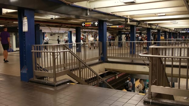 New York City, United States - 31 Aug 2023: Manhattan subway station interior, underground metropolitan transfer. Public metro transport. Railway change hub, passenger traffic junction. People in NYC.