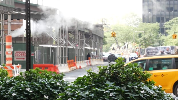 New York City, United States - 9 Sept 2023: Manhattan Downtown Financial District Water street crossroad intersection. USA city life. Urban road car traffic. Yellow taxi. Smoke stack and scaffolding.