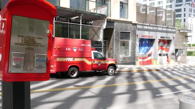New York City, United States - 31 Aug 2023: NYFD car, USA fire department truck, american firefighters vehicle or fire fighter engine on NYC street near firemen station. FD 10 house or hall red gates.