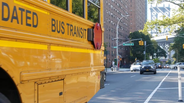 New York City, United States - 7 Sept 2023: Yellow School Bus, Manhattan bridge, schoolbus truck, city street. Children education and USA transportation. American residential district school shuttle.